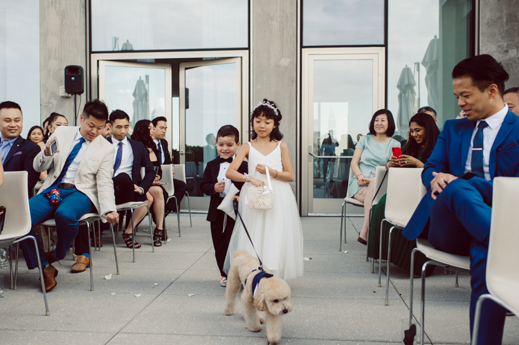 Public Hotel NYC spring rooftop wedding with Stella and Peter. NYC began to loosen COVID restrictions so events and weddings were finally allowed. Stella and Peter were able to keep their original wedding date, but unfortunately Stella's parents couldn't make it to the wedding due to COVID travel restrictions. Stella and Peter's wedding took place on 17th floor with rooftop access at the Public Hotel. Their wedding ceremony was on the rooftop, as well as their first look and some photos then we wandered around the hotel and took some epic photos at the pent house and escalator. Public Hotel NYC was so fun to photograph and I had the coolest, the most chill couple to work with. Stella and Peter's epic wedding at Public Hotel NYC photographed by Karis | Hey Karis.